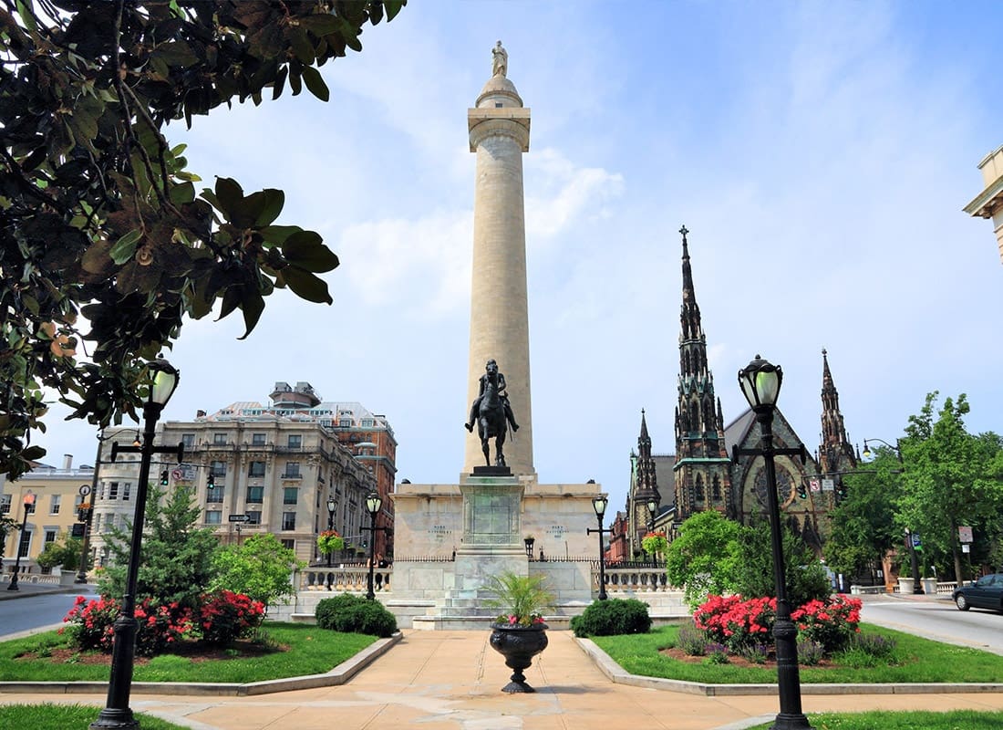 Baltimore, MD - State of a Man Riding a Horse With Historical Buildings and an Old Church in Mt Vernon, Baltimore, MD